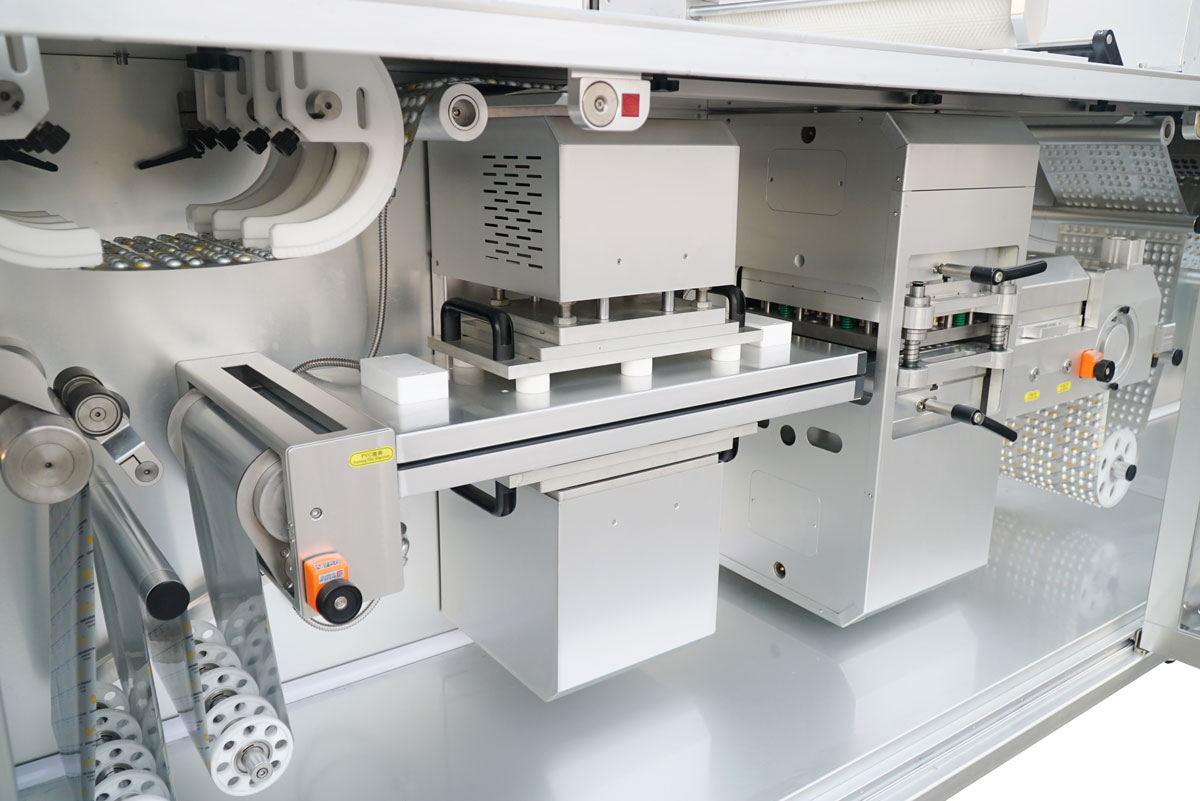 BMR270 Rotary Blister Machine - Forming Station Detail Close-up view of the precision blister forming station on the BMR270 high-speed rotary blister packaging machine, showcasing its robust mechanical design and efficient material handling capabilities for mass pharmaceutical production.