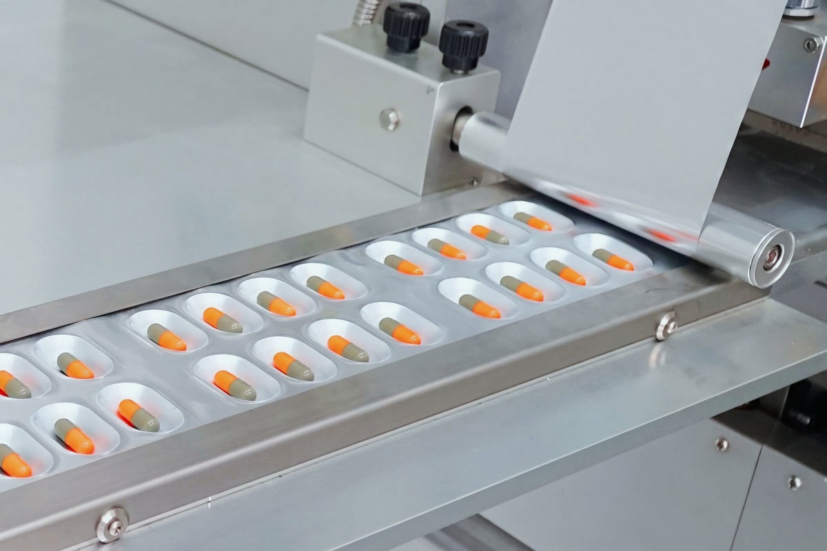 BMP100 Blister Machine Feeding Area Product feeding area of the Jornen BMP100 laboratory blister machine showing solid dose distribution.