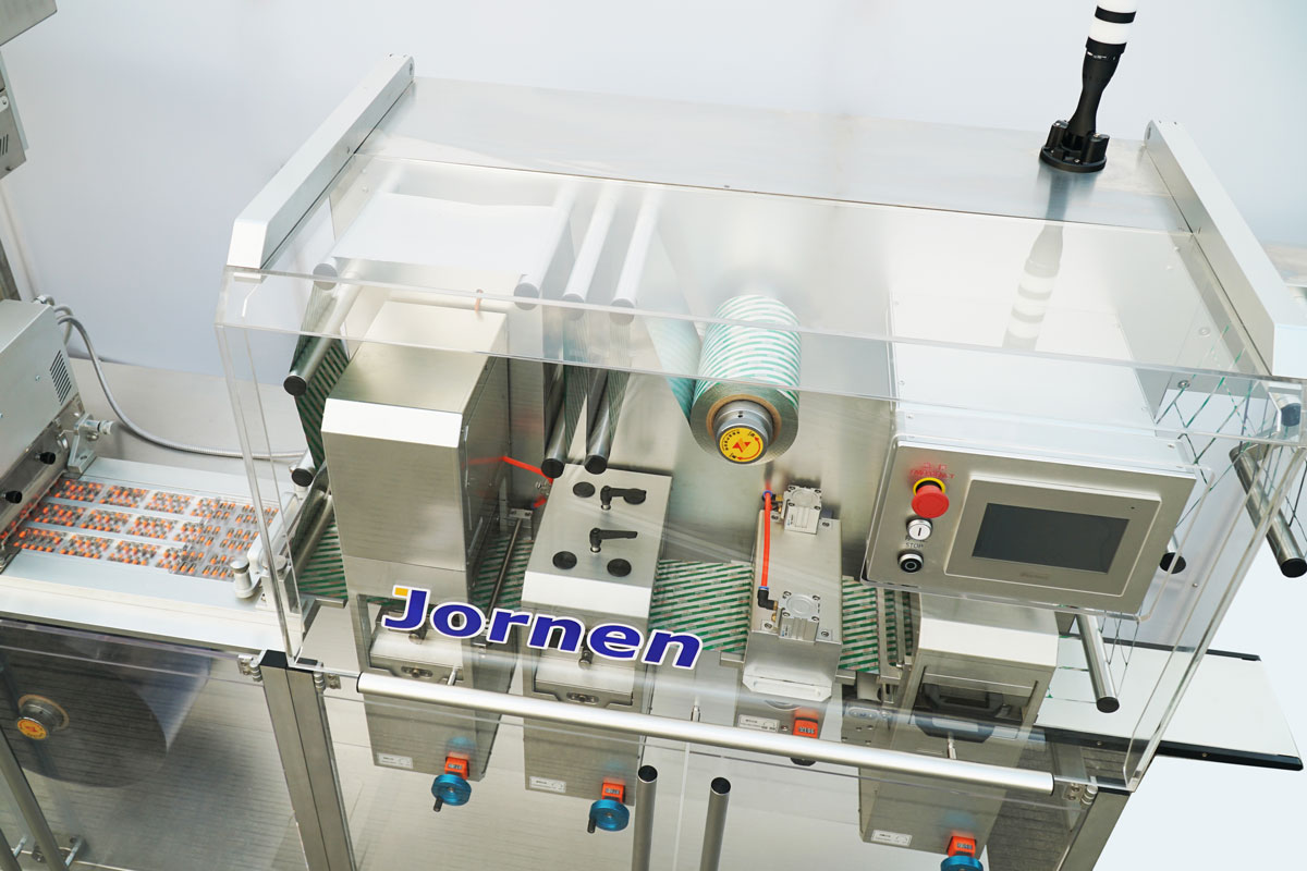 Transparent interlocked safety enclosure on the JORNEN BMP180 blister machine ensuring operator protection and cGMP compliance
