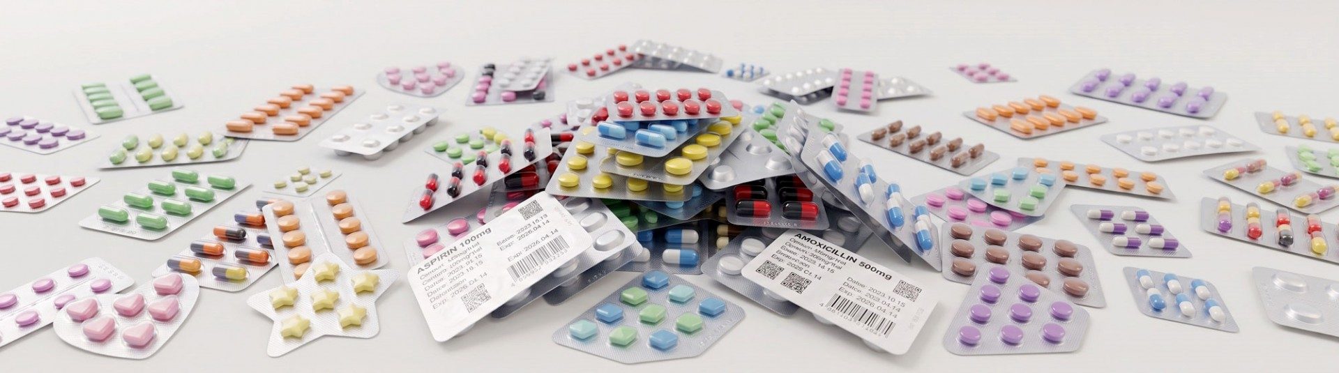 A diverse collection of pharmaceutical blister packs containing various colorful tablets and capsules